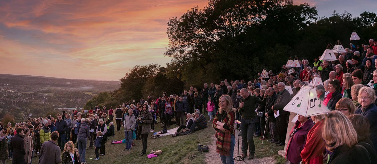 Crowd standing on Box Hill at dusk